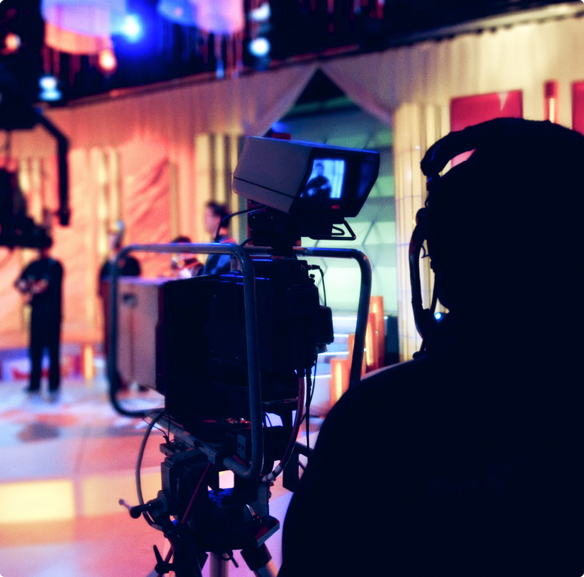 photograph of a person using a videocamera on the set of a tv show